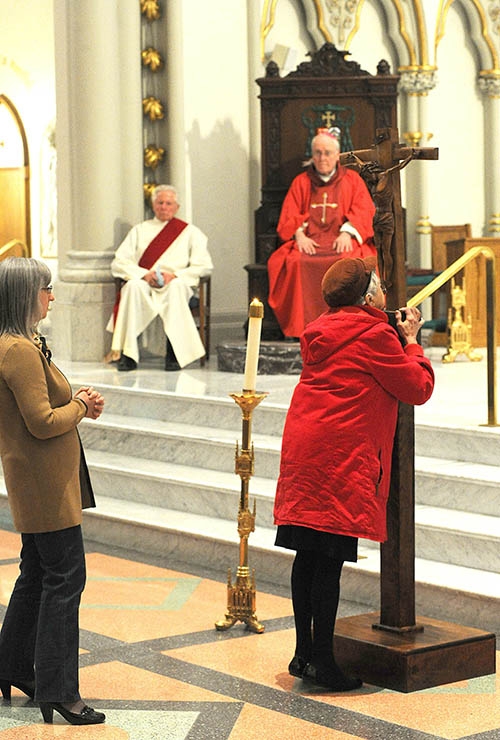 Attendees of Good Friday at St. Joseph Cathedral venerate at the cross during the Solemn Celebration of the Lord's Passion. (Dan Cappellazzo/Staff Photographer)